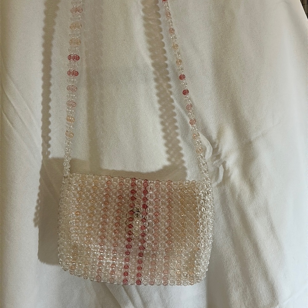 A beautiful simple pink beaded purse by the brand Issac Mizrahi New York.